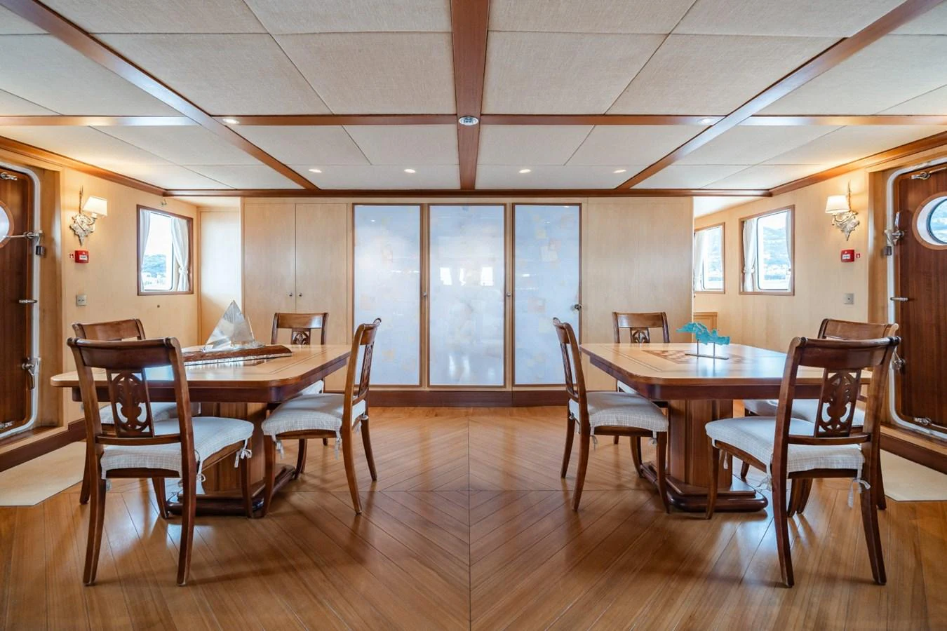 The yacht's dining area features elegant wooden furniture and ample natural light. aboard DIONE STAR Yacht for Sale