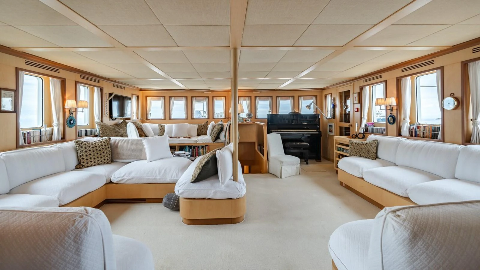 The spacious salon features ample seating with plush white sofas and large windows for natural light. aboard DIONE STAR Yacht for Sale