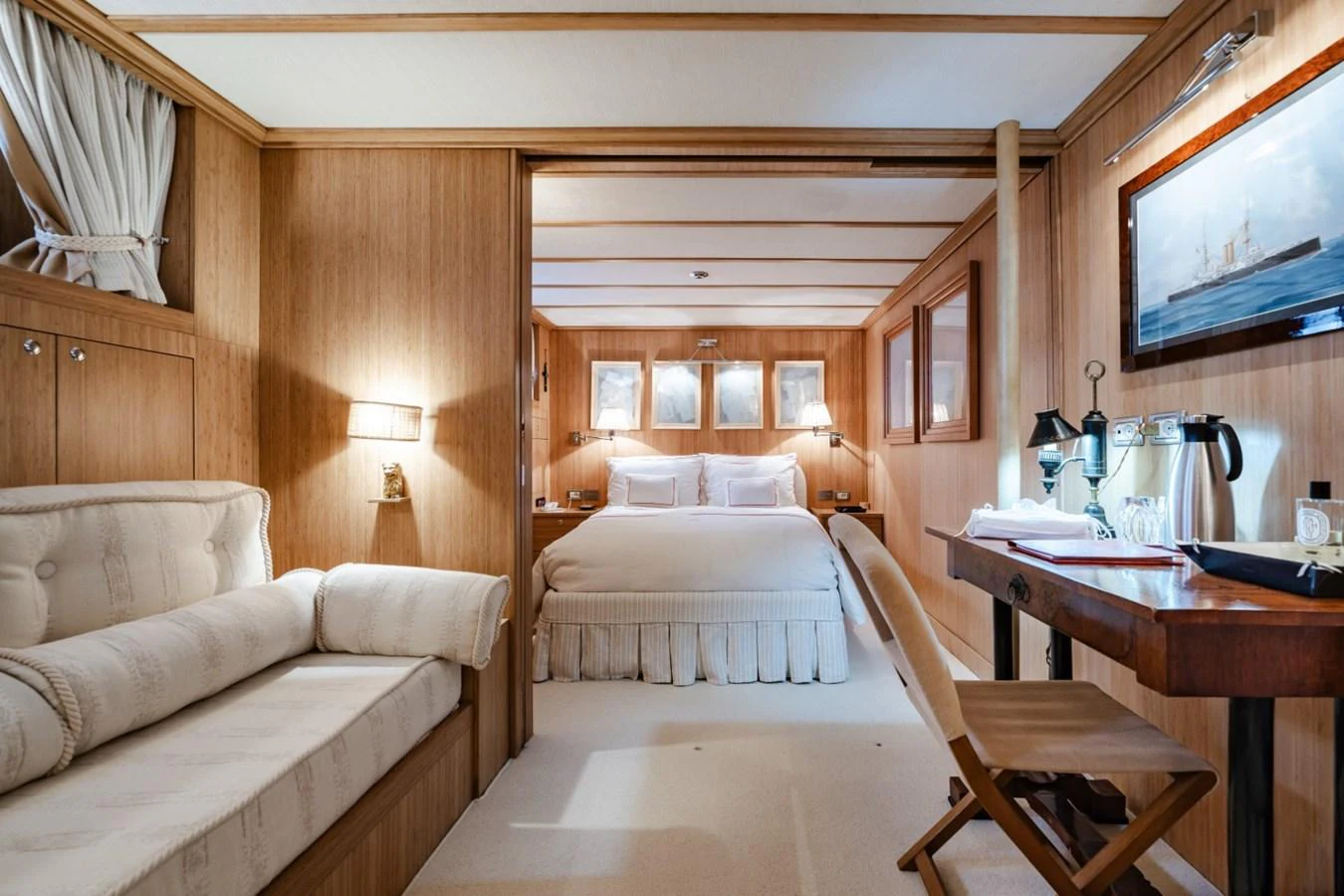 The master stateroom features a cozy and elegant design with warm wood paneling and luxurious furnishings. aboard DIONE STAR Yacht for Sale