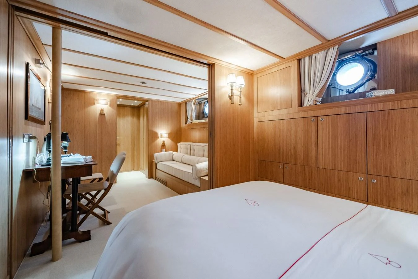 A cozy stateroom with wooden paneling and a comfortable bed. aboard DIONE STAR Yacht for Sale