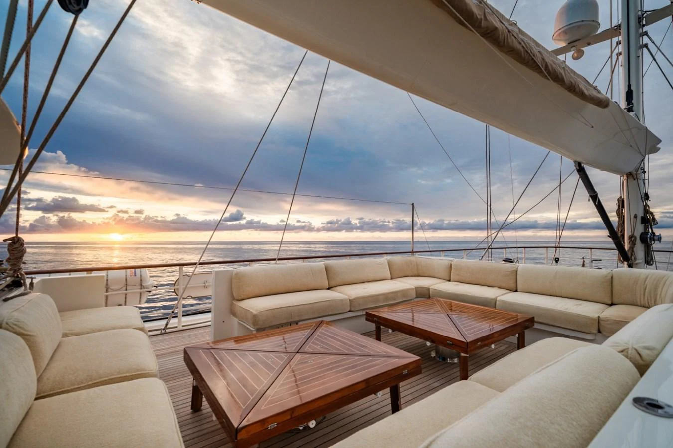 The aft deck features luxurious seating with a stunning ocean view at sunset. aboard DIONE STAR Yacht for Sale