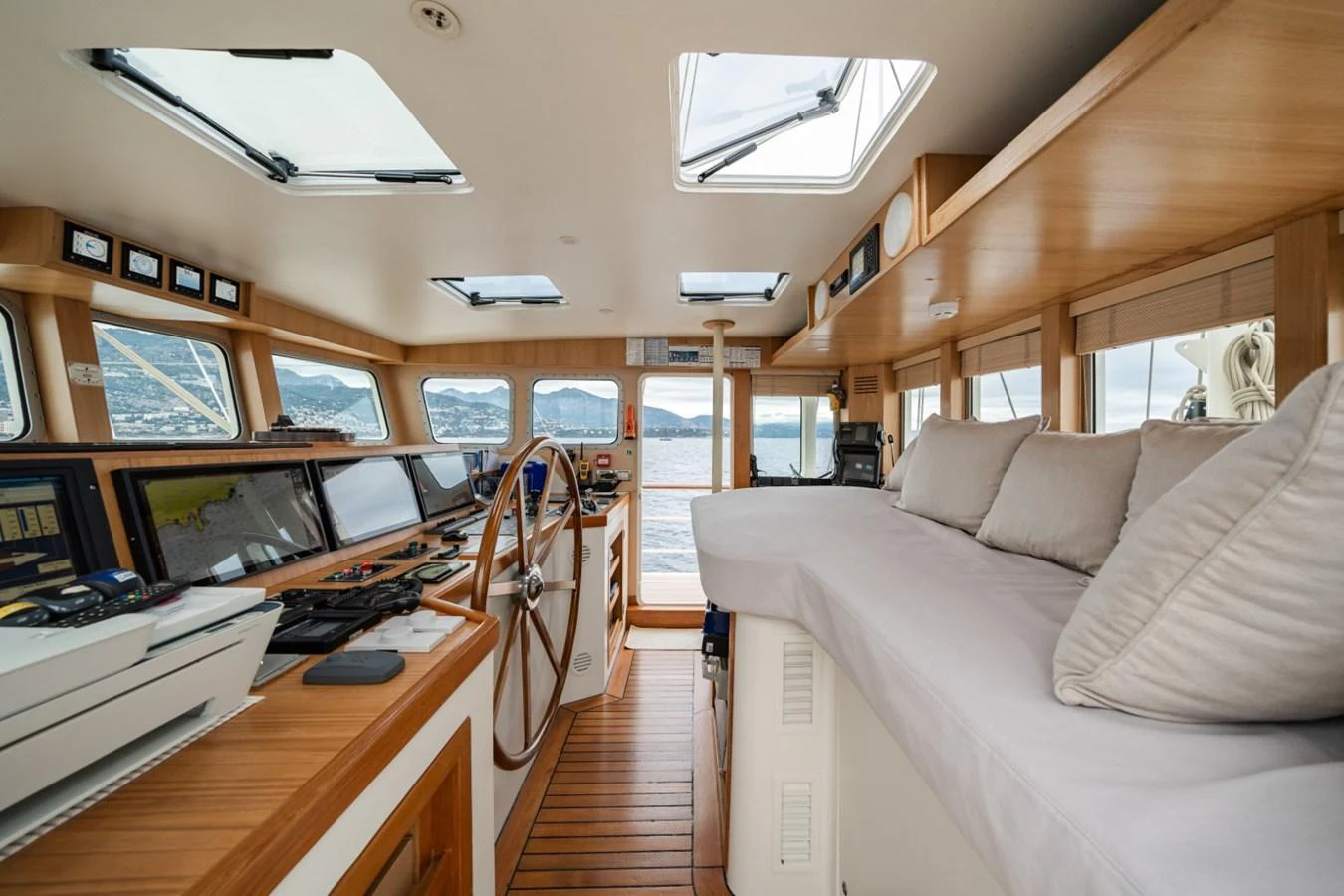 The helm area features a spacious and well-lit control station with comfortable seating and panoramic views. aboard DIONE STAR Yacht for Sale