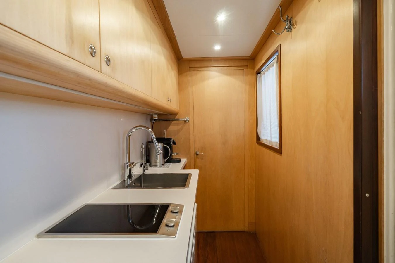 A compact and well-equipped galley with modern appliances and wooden cabinetry. aboard DIONE STAR Yacht for Sale