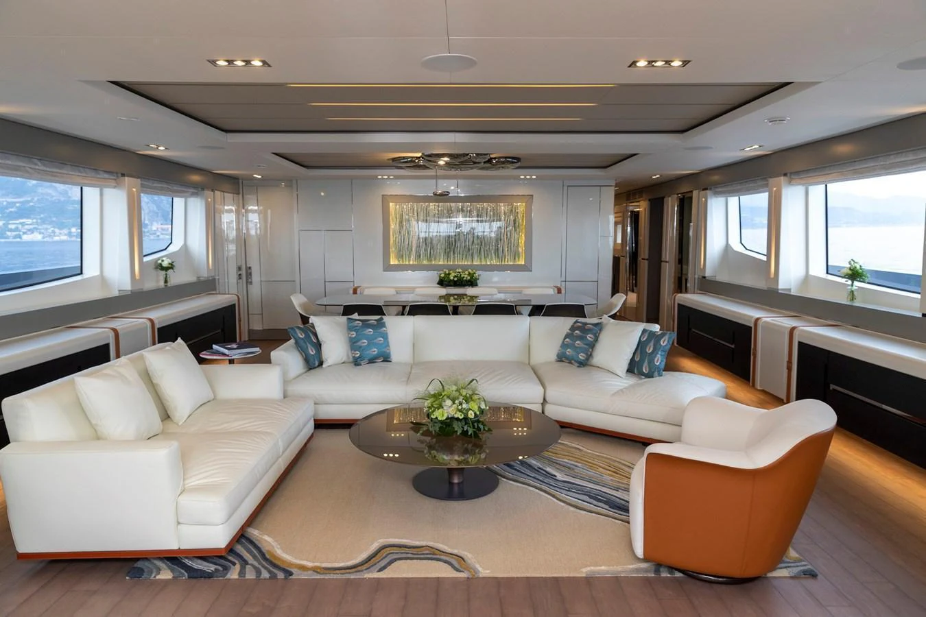 The yacht's salon features a spacious and elegantly designed seating area with large windows offering stunning views. aboard PERSHING 140 Yacht for Sale