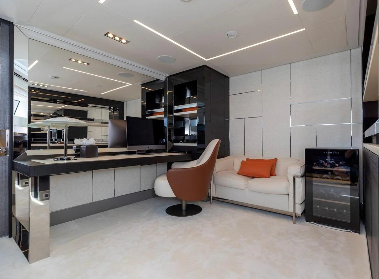 This luxurious yacht interior features a modern lounge area with sleek furnishings and a sophisticated ambiance. aboard PERSHING 140 Yacht for Sale