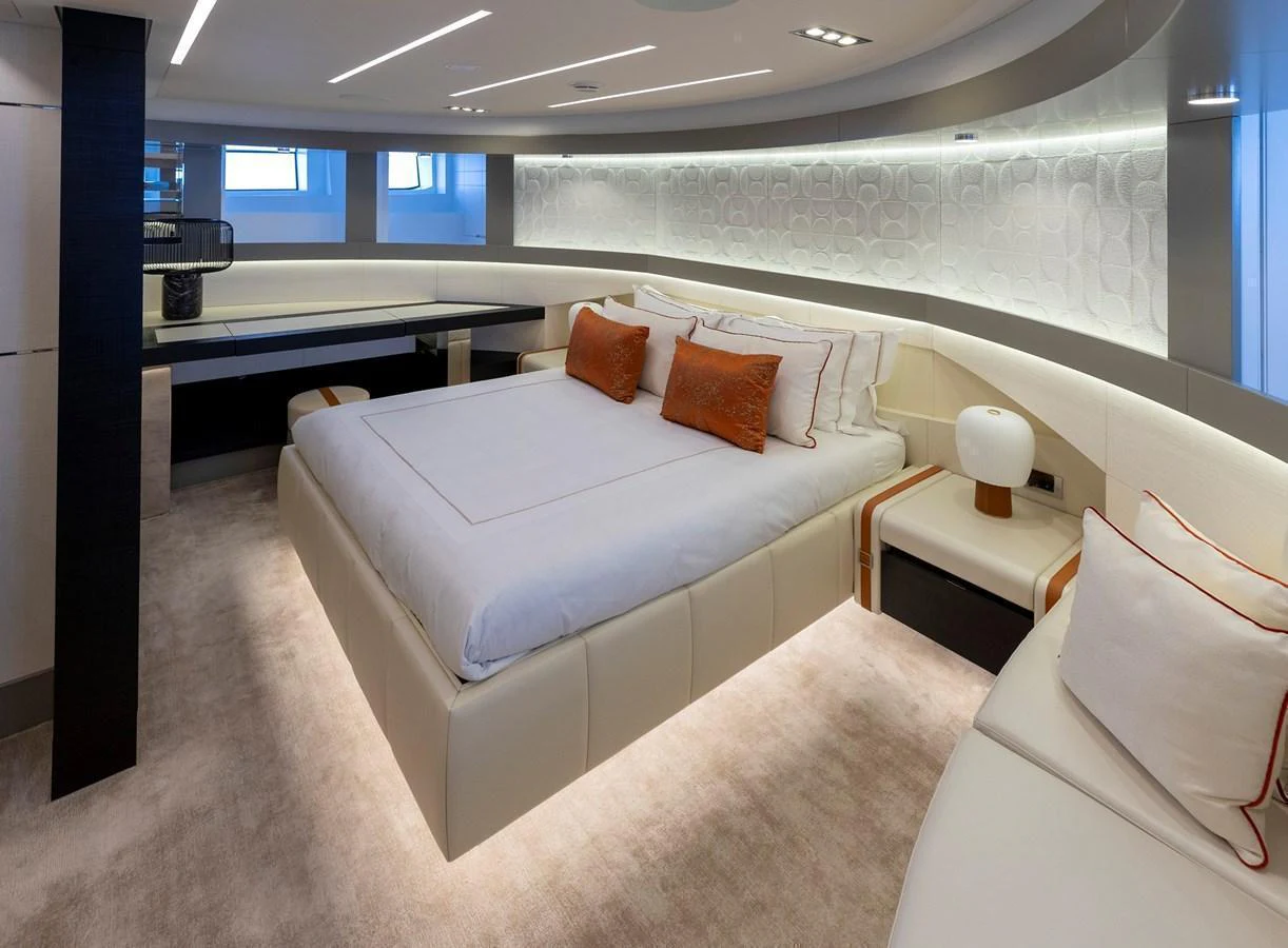 The master stateroom features a luxurious bed with elegant lighting and modern decor. aboard PERSHING 140 Yacht for Sale