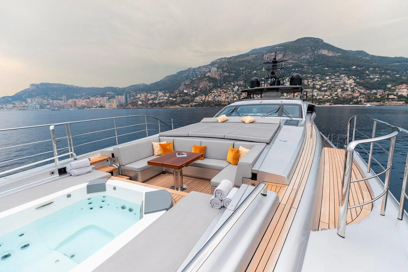 The foredeck features a luxurious lounging area with a jacuzzi, offering stunning views of the coastline. aboard PERSHING 140 Yacht for Sale