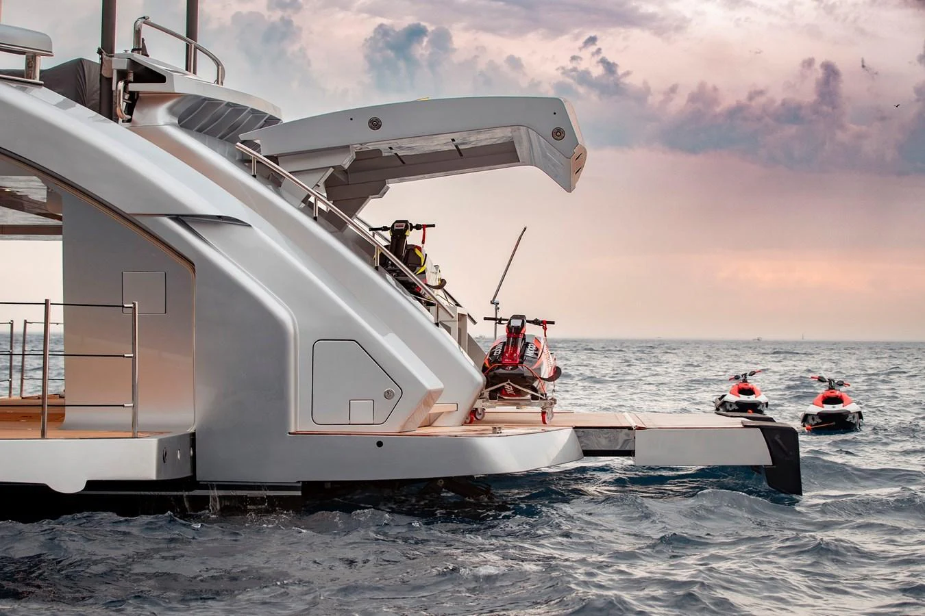 The yacht's aft deck features a sleek design with a platform for launching jet skis into the water. aboard PERSHING 140 Yacht for Sale