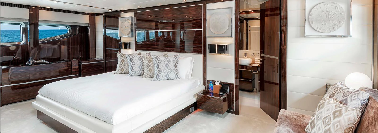The master stateroom features a luxurious bed, elegant decor, and ample natural light. aboard ANTELOPE IV Yacht for Sale
