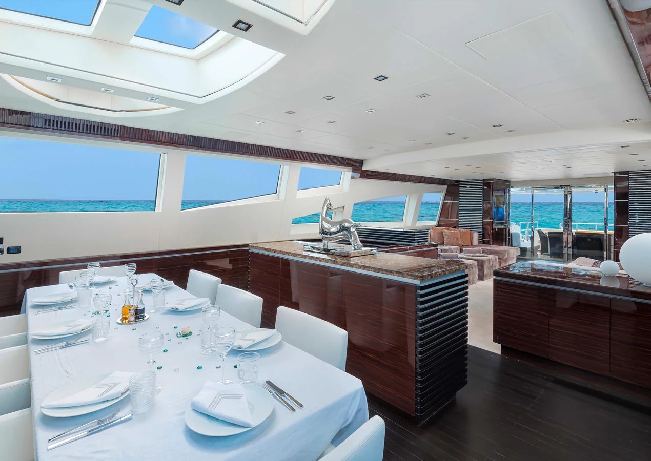 The yacht's salon features a spacious dining area with panoramic ocean views and luxurious furnishings. aboard ANTELOPE IV Yacht for Sale