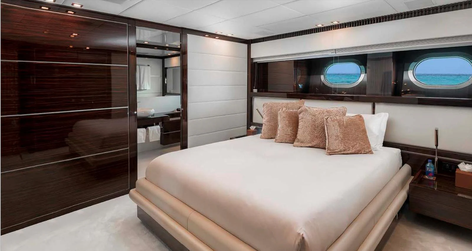 The master stateroom features a luxurious bed with plush pillows and elegant wood finishes. aboard ANTELOPE IV Yacht for Sale