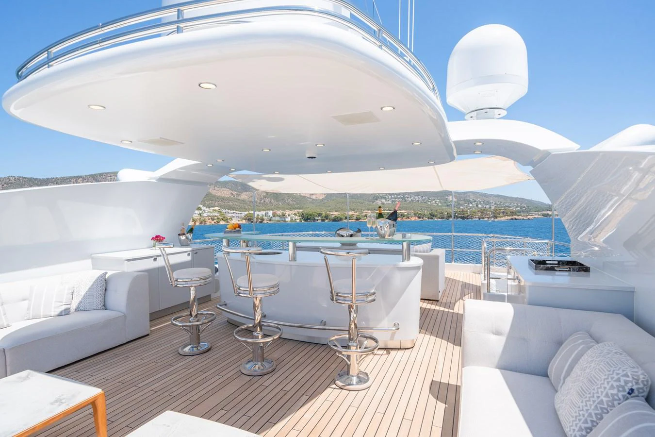 The sundeck features a stylish bar area with ample seating and panoramic views. aboard TITIAN PEARL Yacht for Sale