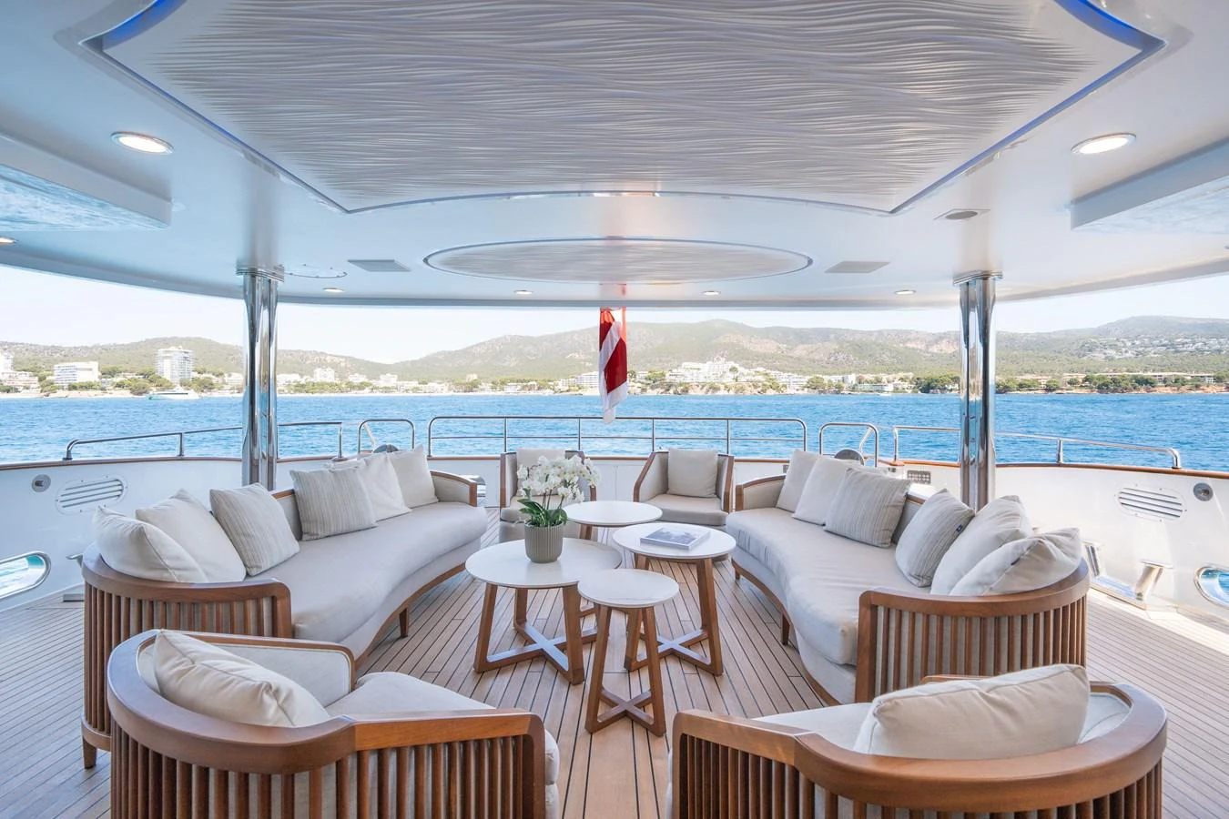 The aft deck features elegant seating with a stunning view of the water. aboard TITIAN PEARL Yacht for Sale