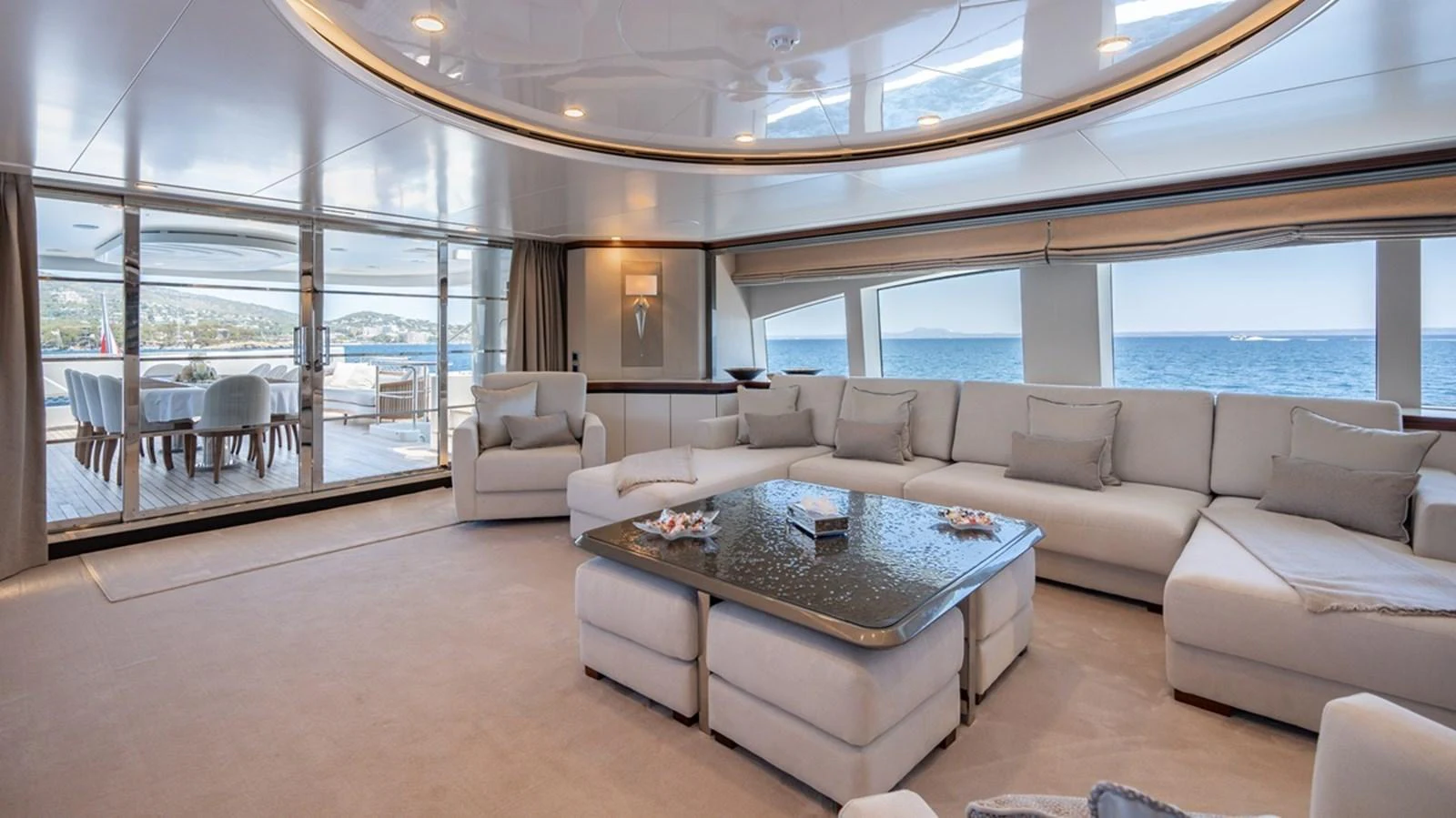 The spacious salon offers panoramic views and luxurious comfort with plush seating and elegant decor. aboard TITIAN PEARL Yacht for Sale