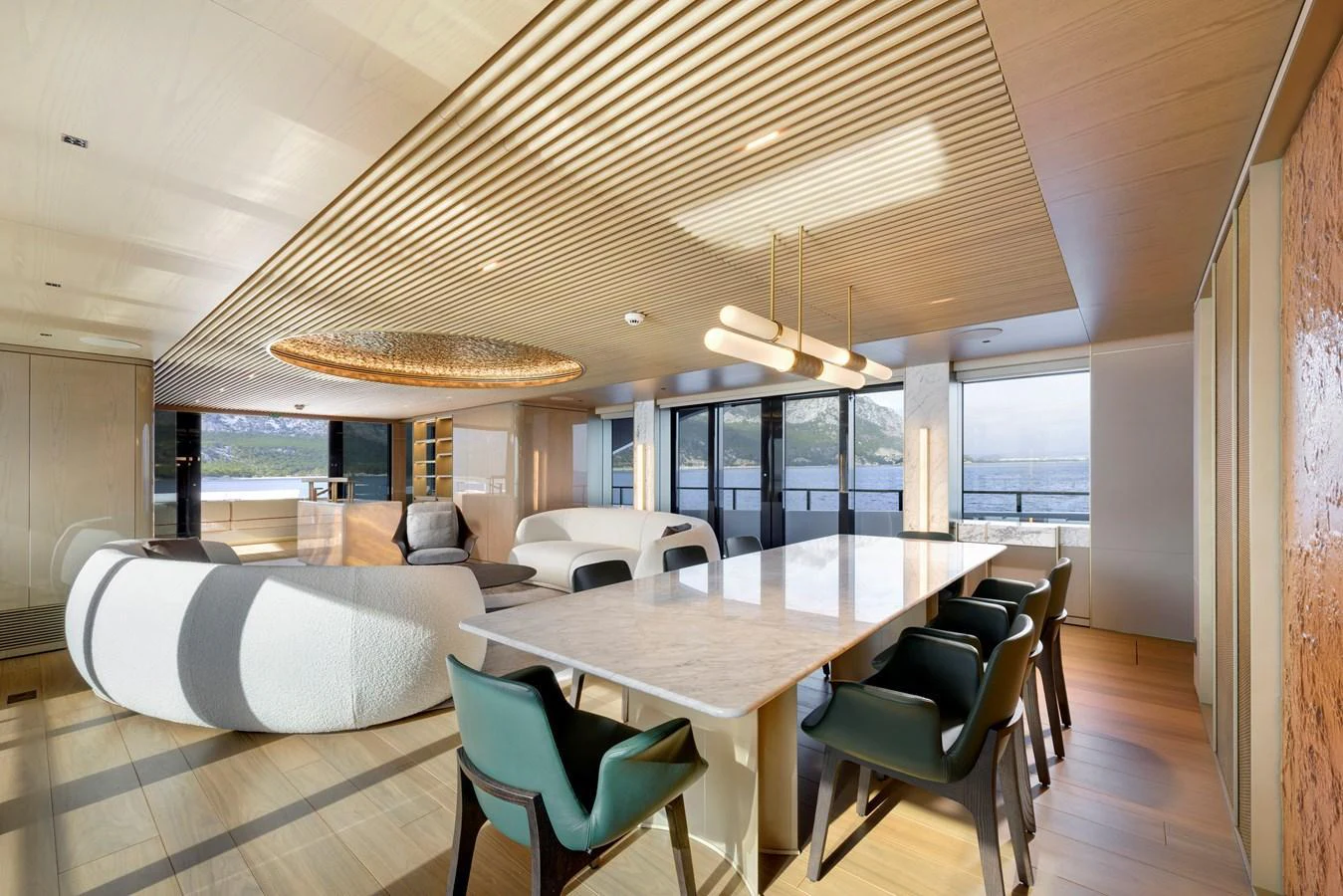 The salon features modern furnishings with ample natural light and panoramic views. aboard XIMENA Yacht for Sale