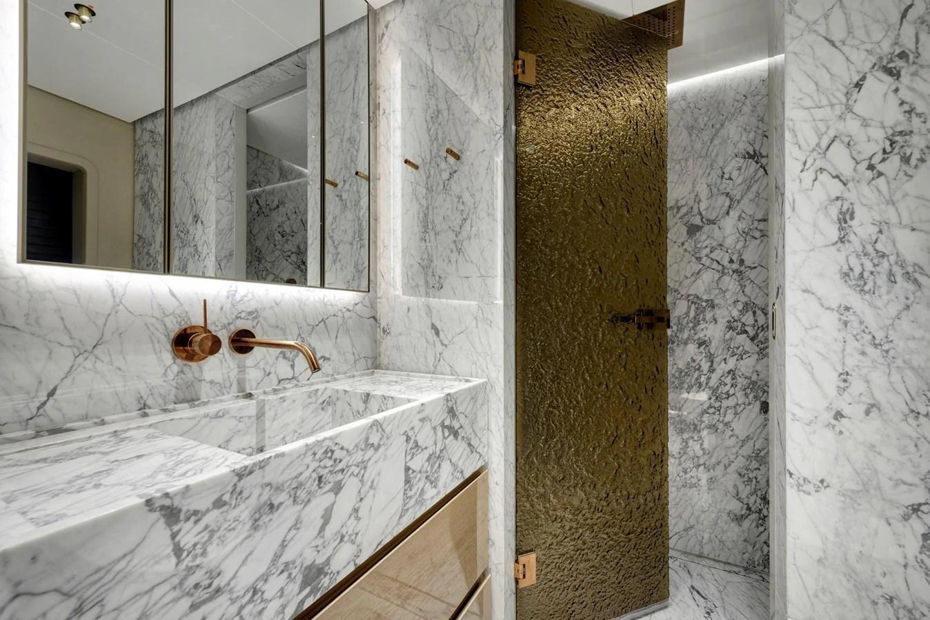 The yacht's bathroom features luxurious marble surfaces and elegant fixtures. aboard XIMENA Yacht for Sale