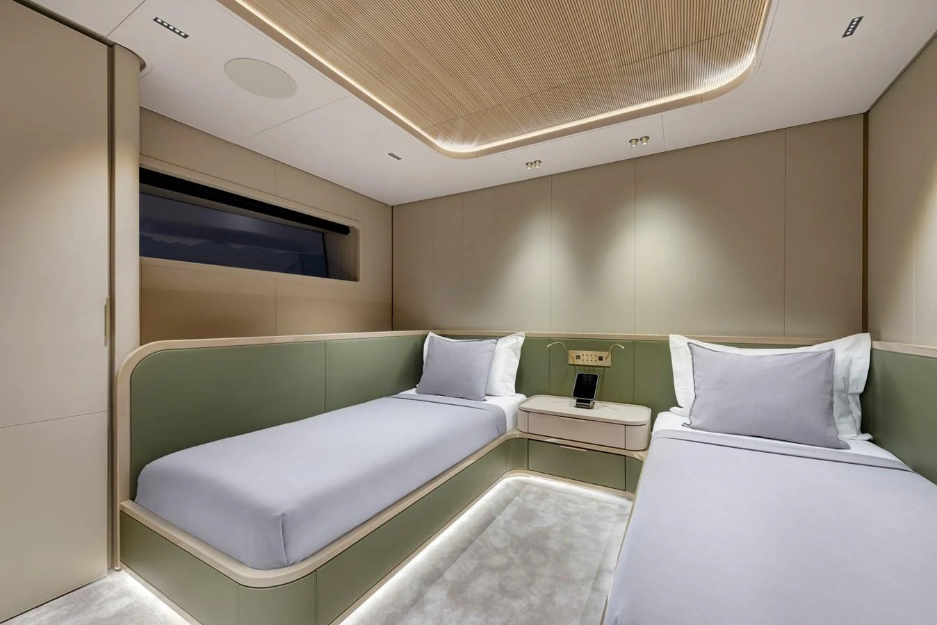 The guest stateroom features twin beds with modern, minimalist design and ambient lighting. aboard XIMENA Yacht for Sale