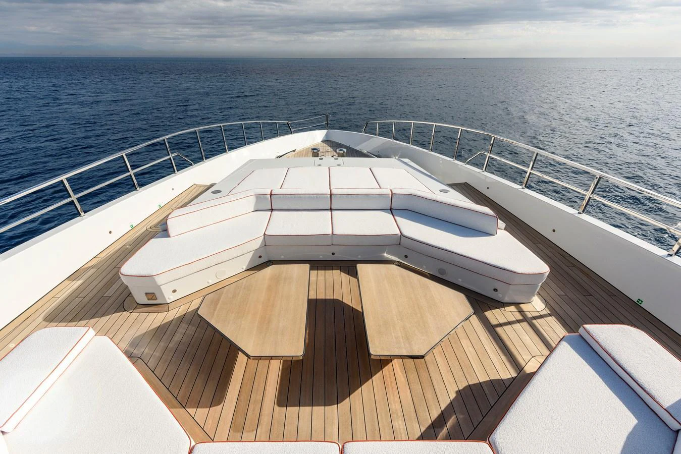 The foredeck features a spacious sunbathing area with luxurious cushioned seating and stunning ocean views. aboard XIMENA Yacht for Sale
