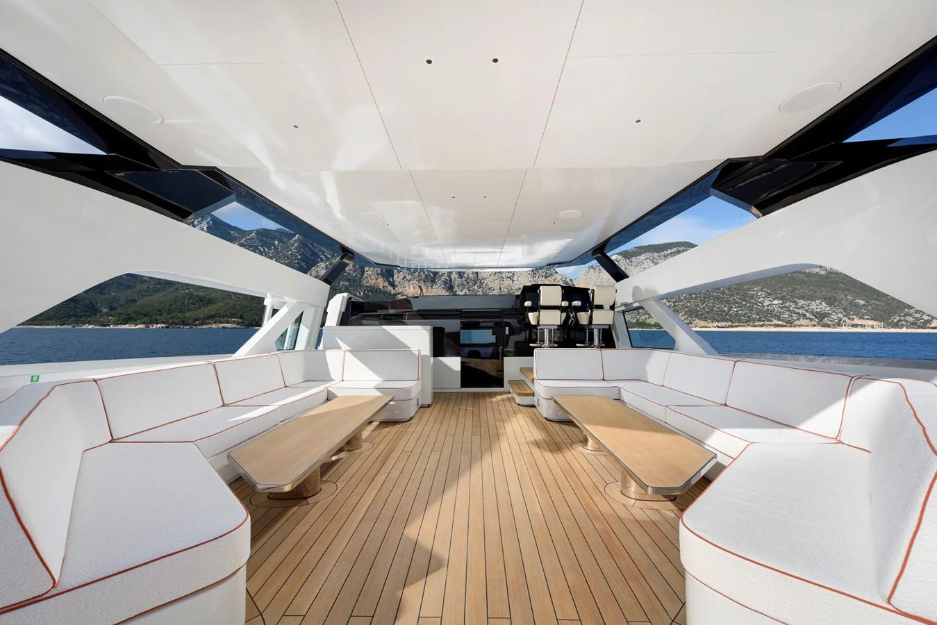The spacious salon features ample seating and panoramic windows, offering stunning views of the surrounding seascape. aboard XIMENA Yacht for Sale