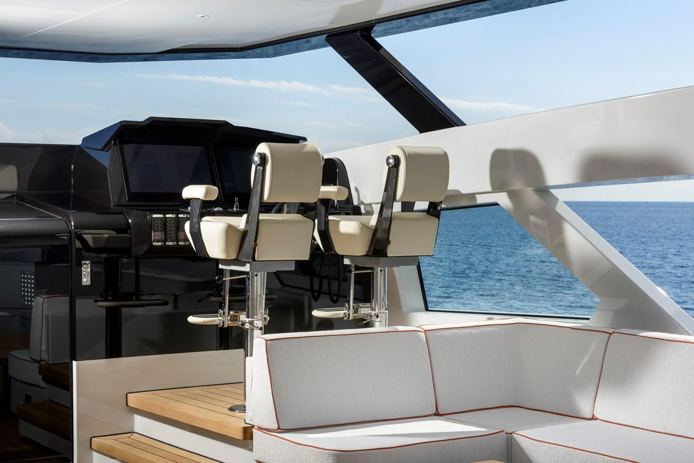 The yacht's helm area features sleek, modern seating with a panoramic view of the sea. aboard XIMENA Yacht for Sale