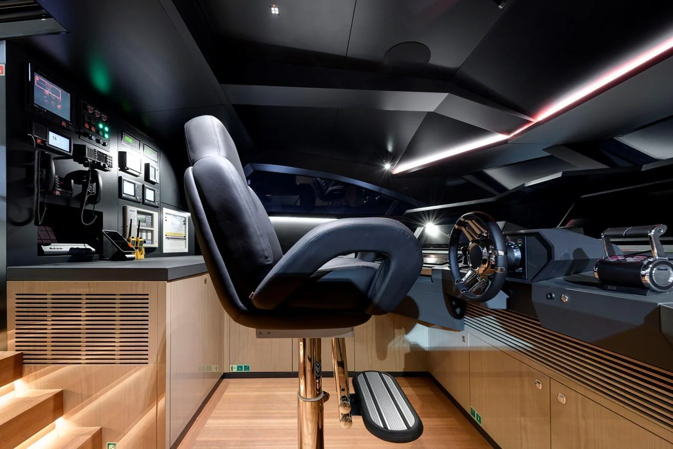 The helm station features a sleek, modern design with advanced navigation equipment and a comfortable captain's chair. aboard XIMENA Yacht for Sale