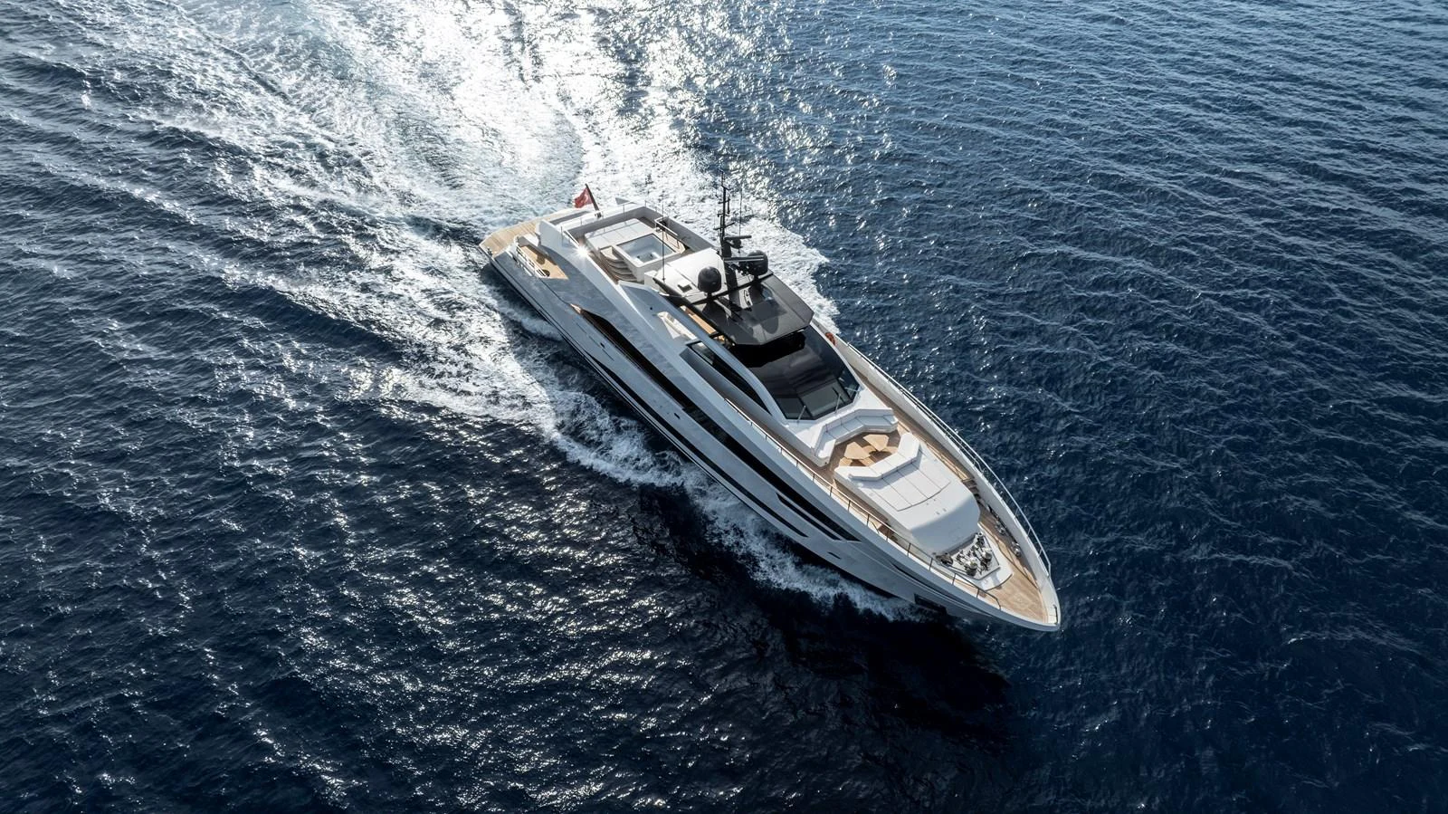 A sleek and modern yacht glides effortlessly through the open sea, showcasing its elegant design and luxurious features. aboard XIMENA Yacht for Sale