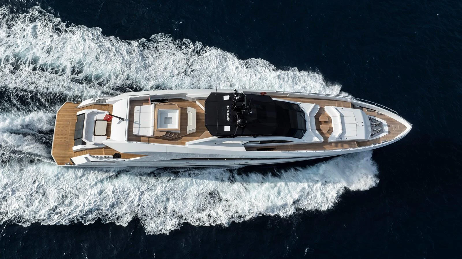 A sleek and modern yacht cruises through the open water, showcasing its elegant design and spacious deck areas. aboard XIMENA Yacht for Sale