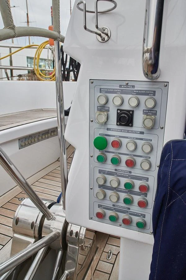 The image showcases a detailed view of the yacht's control panel with various buttons and switches. aboard CYCLOS III Yacht for Sale