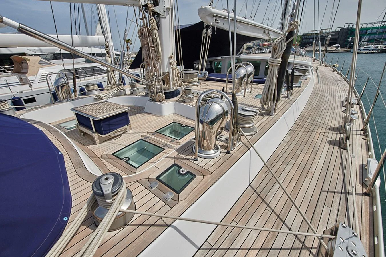 The yacht's deck showcases a blend of polished wood and sleek metal fittings, exuding a sense of nautical elegance. aboard CYCLOS III Yacht for Sale