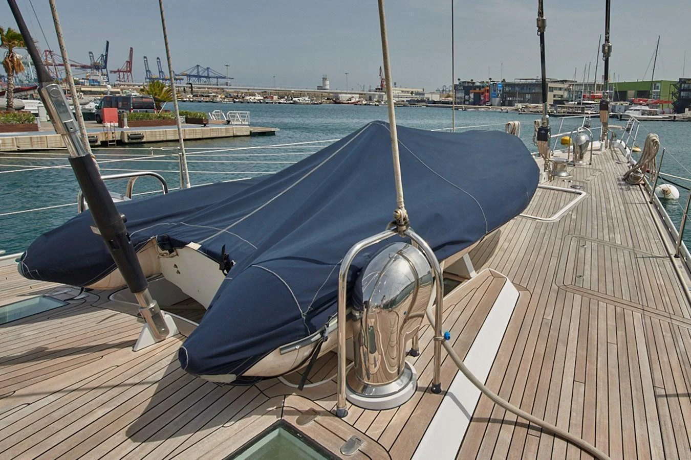 The image showcases a yacht's deck with a covered tender, highlighting the practical aspects of yacht storage and maintenance. aboard CYCLOS III Yacht for Sale