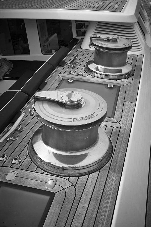 A close-up view of the yacht's deck showcasing the winches and teak flooring. aboard CYCLOS III Yacht for Sale