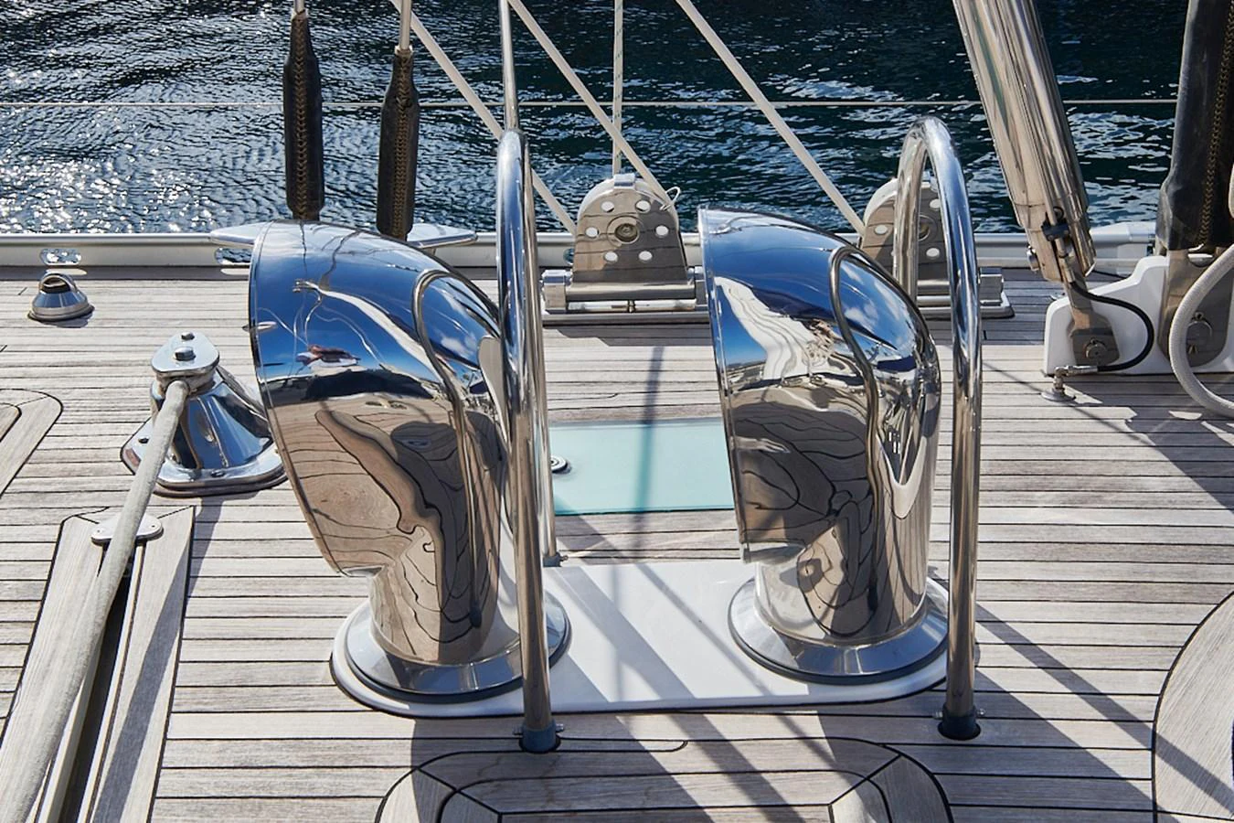 The image showcases polished stainless steel vents on the yacht's deck, reflecting the surrounding environment. aboard CYCLOS III Yacht for Sale