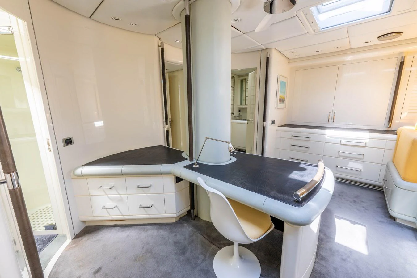 The yacht's interior features a sleek and modern office space with ample storage and natural light. aboard CYCLOS III Yacht for Sale