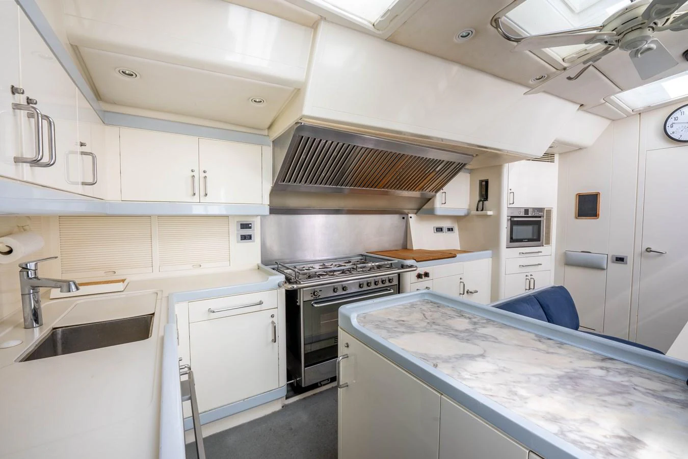 The galley features modern appliances and a sleek marble countertop, perfect for gourmet cooking at sea. aboard CYCLOS III Yacht for Sale