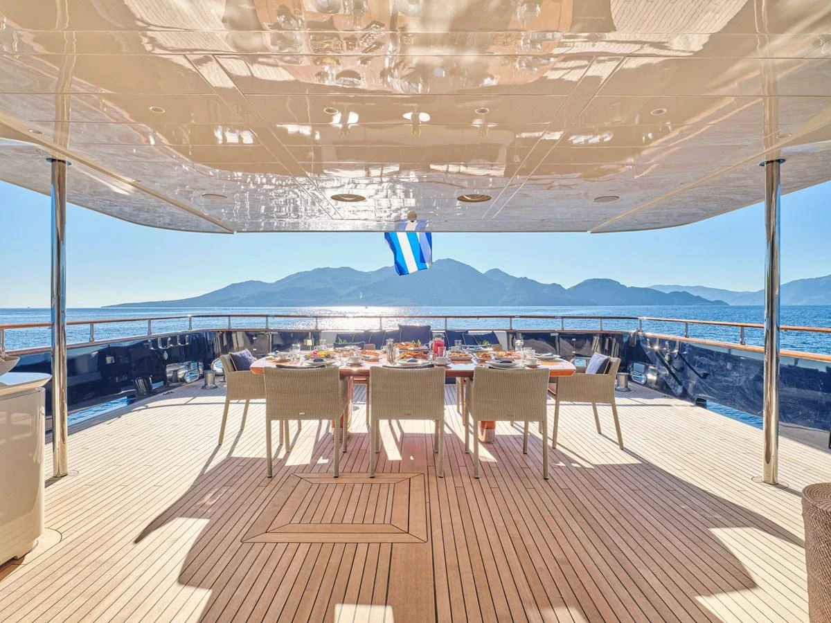 The aft deck offers a stunning dining area with panoramic ocean views. aboard CONDOR A Yacht for Sale