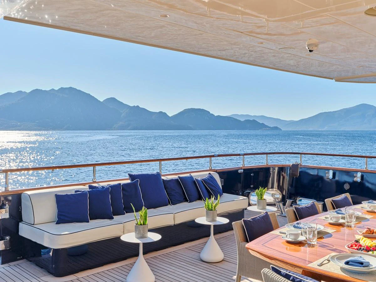 The aft deck offers a luxurious outdoor dining and lounging area with stunning sea views. aboard CONDOR A Yacht for Sale