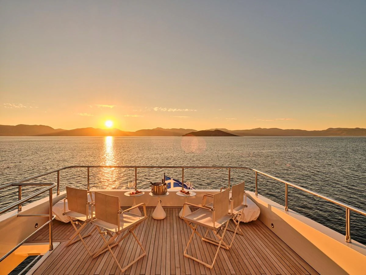 The aft deck offers a serene setting with comfortable seating to enjoy the sunset over the water. aboard CONDOR A Yacht for Sale