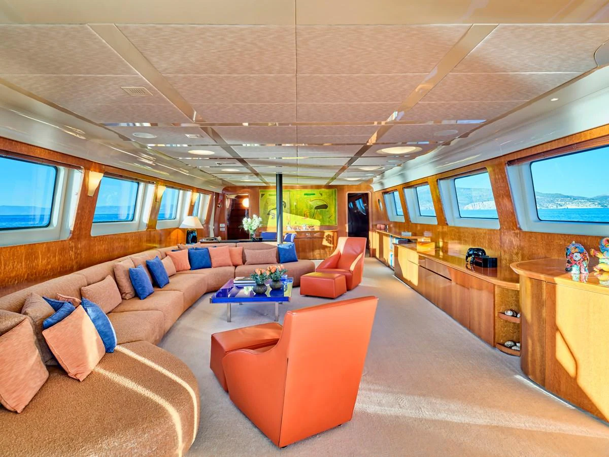 The yacht's salon features luxurious seating with panoramic windows offering stunning views. aboard CONDOR A Yacht for Sale