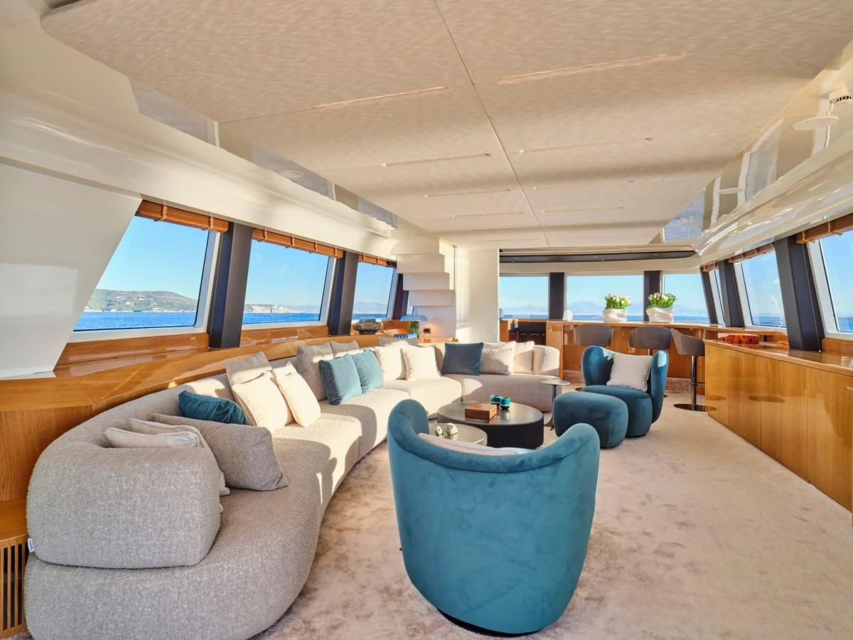 The yacht's salon features plush seating, large windows, and elegant decor, offering a luxurious space for relaxation. aboard CONDOR A Yacht for Sale