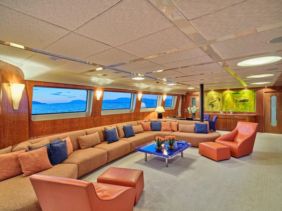 The salon features a spacious seating area with large windows offering stunning ocean views. aboard CONDOR A Yacht for Sale