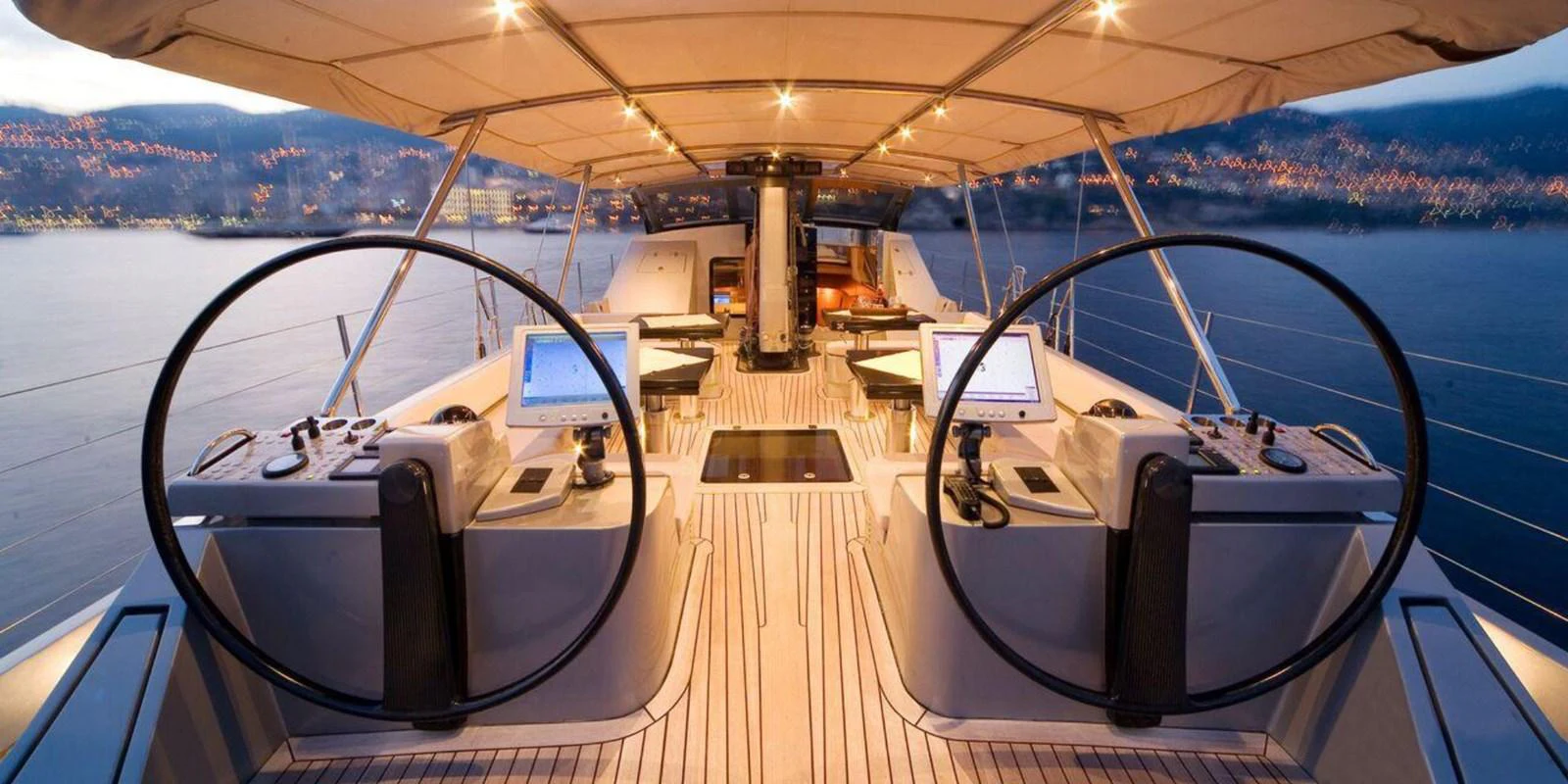 The helm station features dual steering wheels and advanced navigation systems under a spacious canopy. aboard YAMAKAY Yacht for Sale