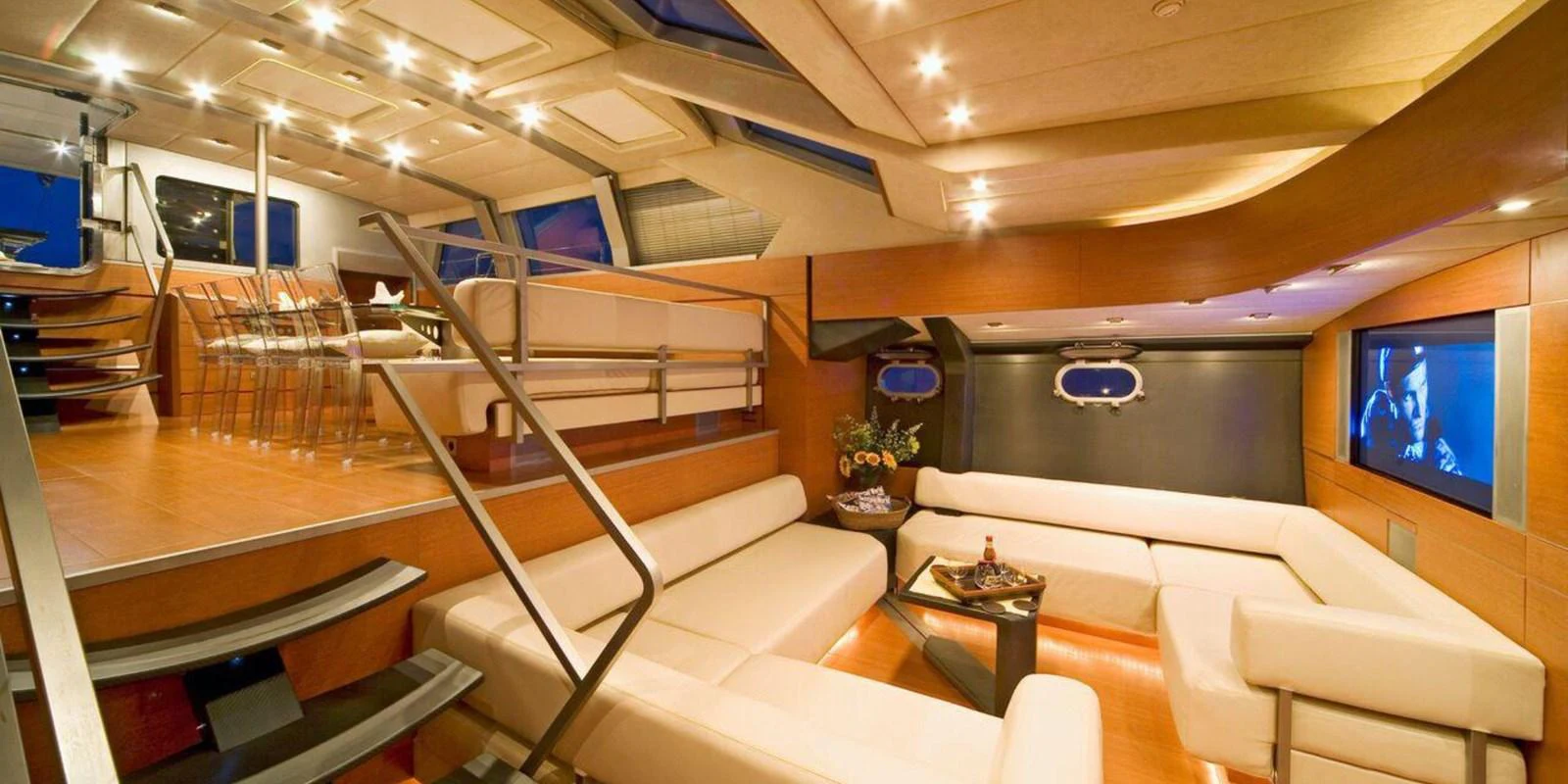 The yacht's salon features luxurious seating, modern lighting, and a sophisticated entertainment system. aboard YAMAKAY Yacht for Sale