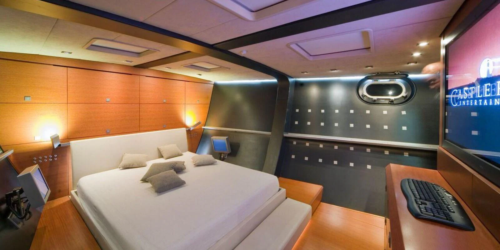 The master stateroom features a modern design with a spacious bed and advanced entertainment system. aboard YAMAKAY Yacht for Sale