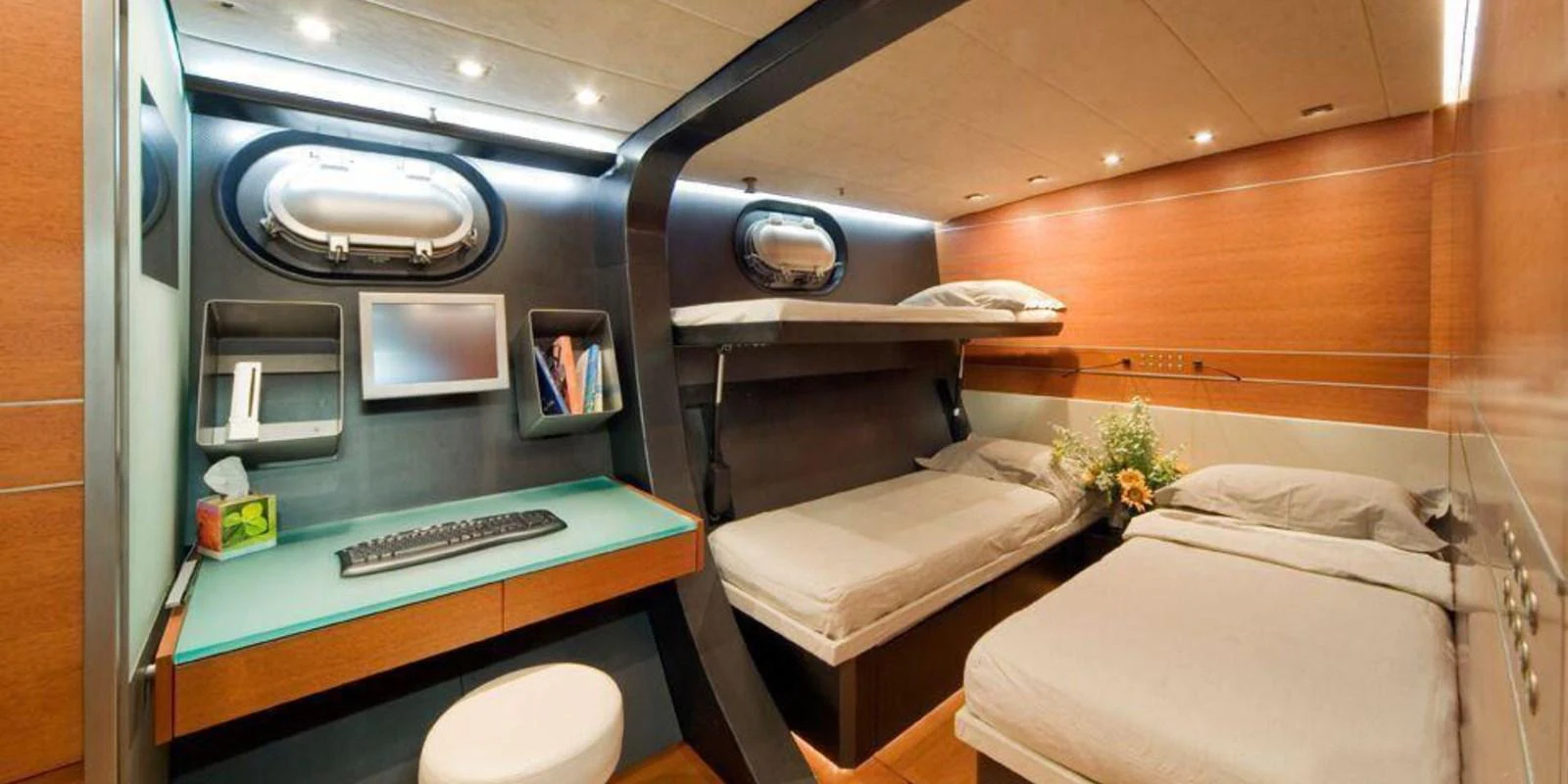 The crew quarters feature practical bunk beds, a workstation, and modern amenities for comfort. aboard YAMAKAY Yacht for Sale