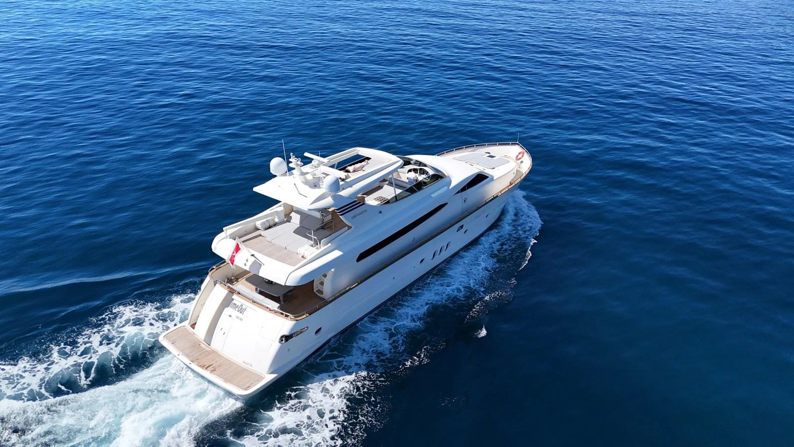 A sleek and modern yacht cruises through the open sea, showcasing its elegant design and luxurious amenities. aboard TIME OUT TOGETHER Yacht for Sale