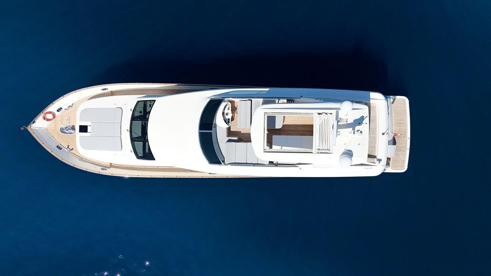 A sleek yacht is captured from an aerial view, showcasing its elegant design and spacious deck areas. aboard TIME OUT TOGETHER Yacht for Sale