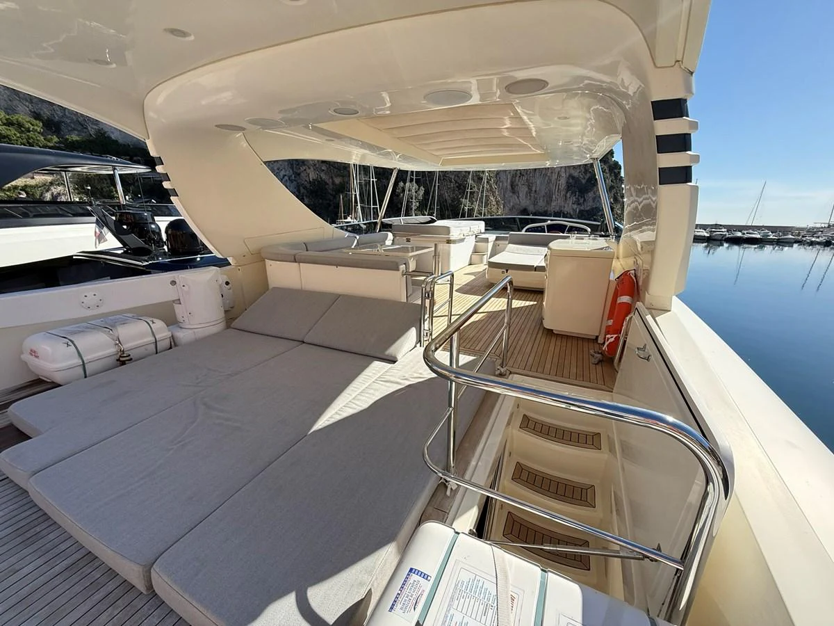 The aft deck features spacious sun loungers and a shaded seating area, perfect for relaxation. aboard TIME OUT TOGETHER Yacht for Sale