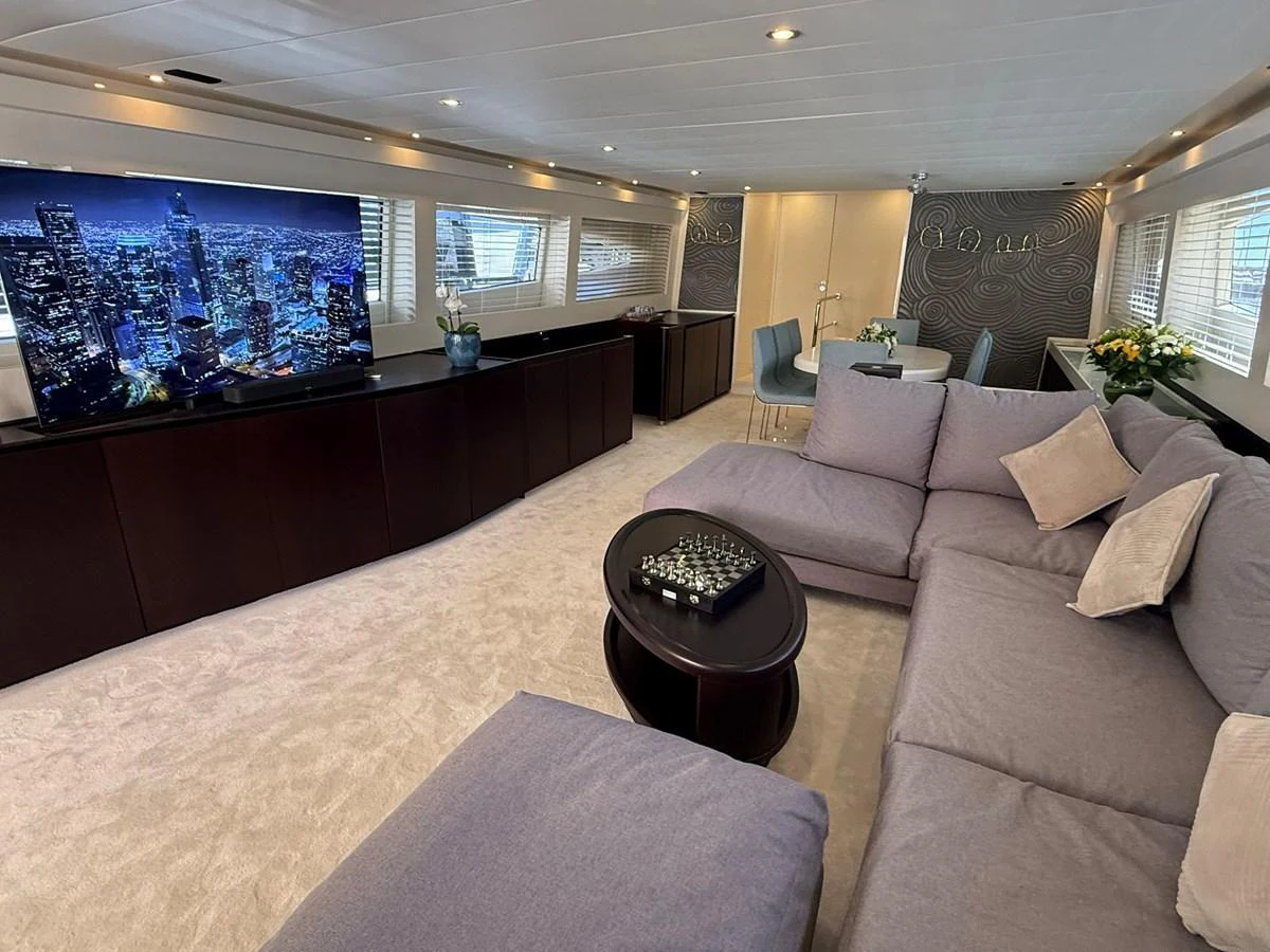 The salon features a spacious seating area with a large TV and elegant decor. aboard TIME OUT TOGETHER Yacht for Sale