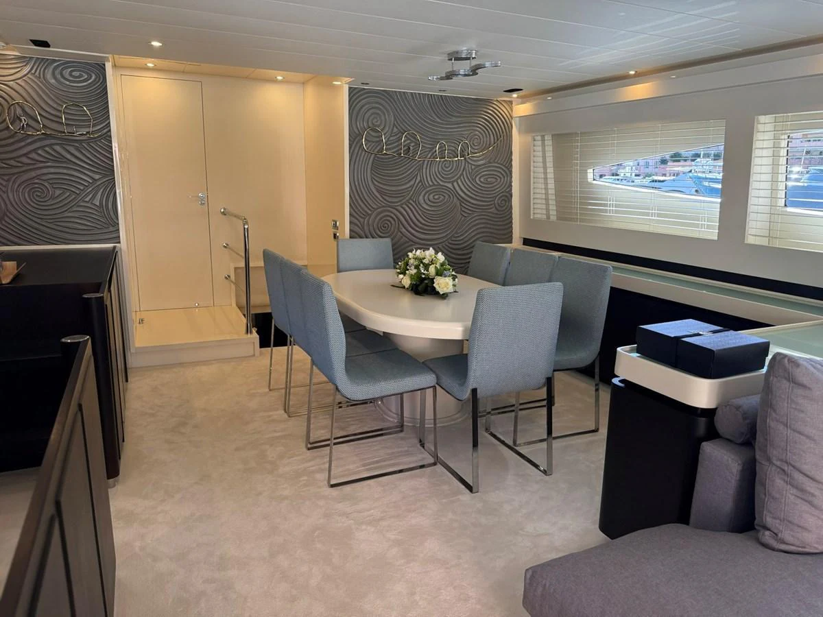 The yacht's dining area features a modern table with comfortable seating and elegant decor. aboard TIME OUT TOGETHER Yacht for Sale