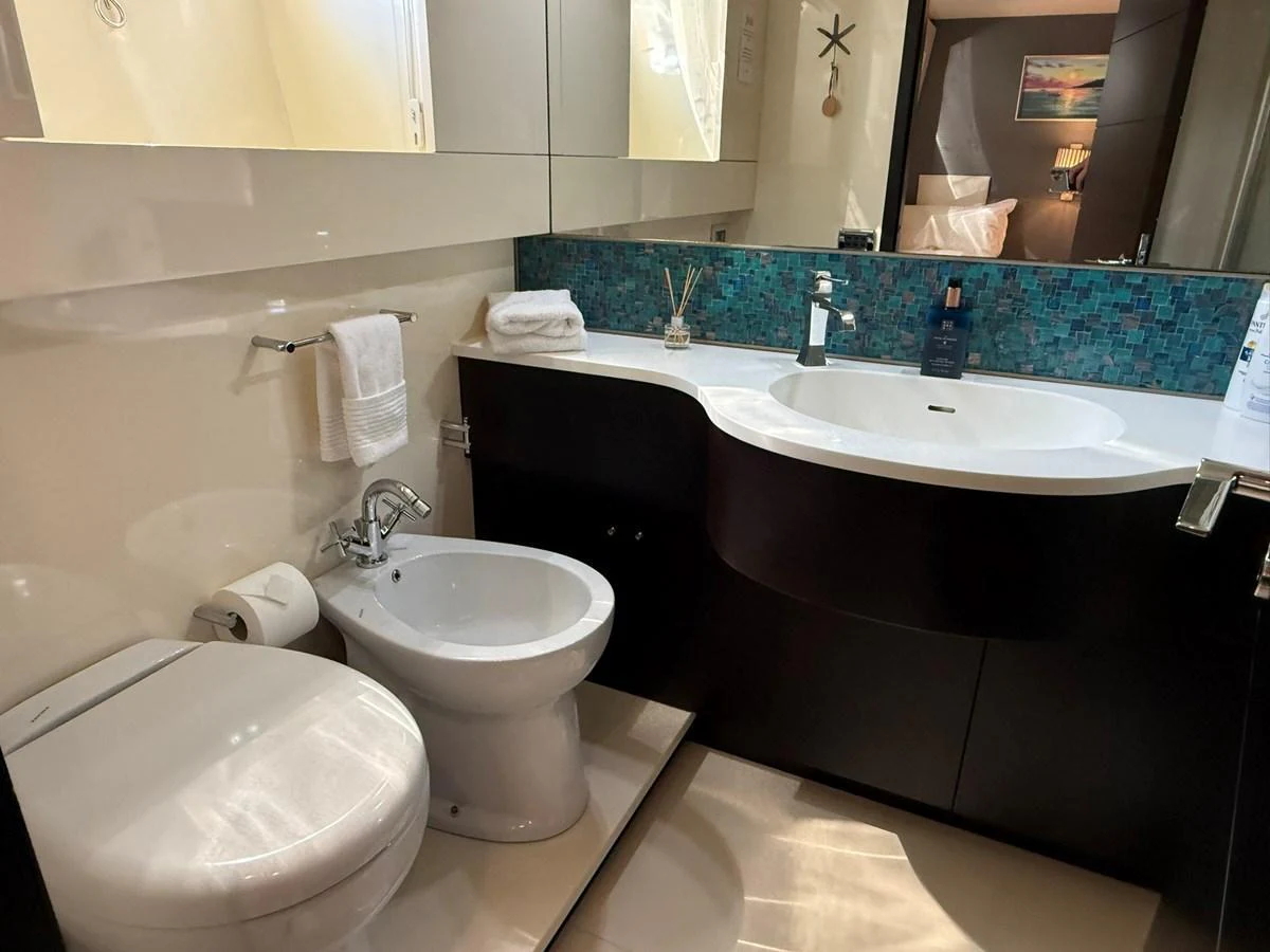 The yacht's bathroom features modern fixtures and a sleek design. aboard TIME OUT TOGETHER Yacht for Sale